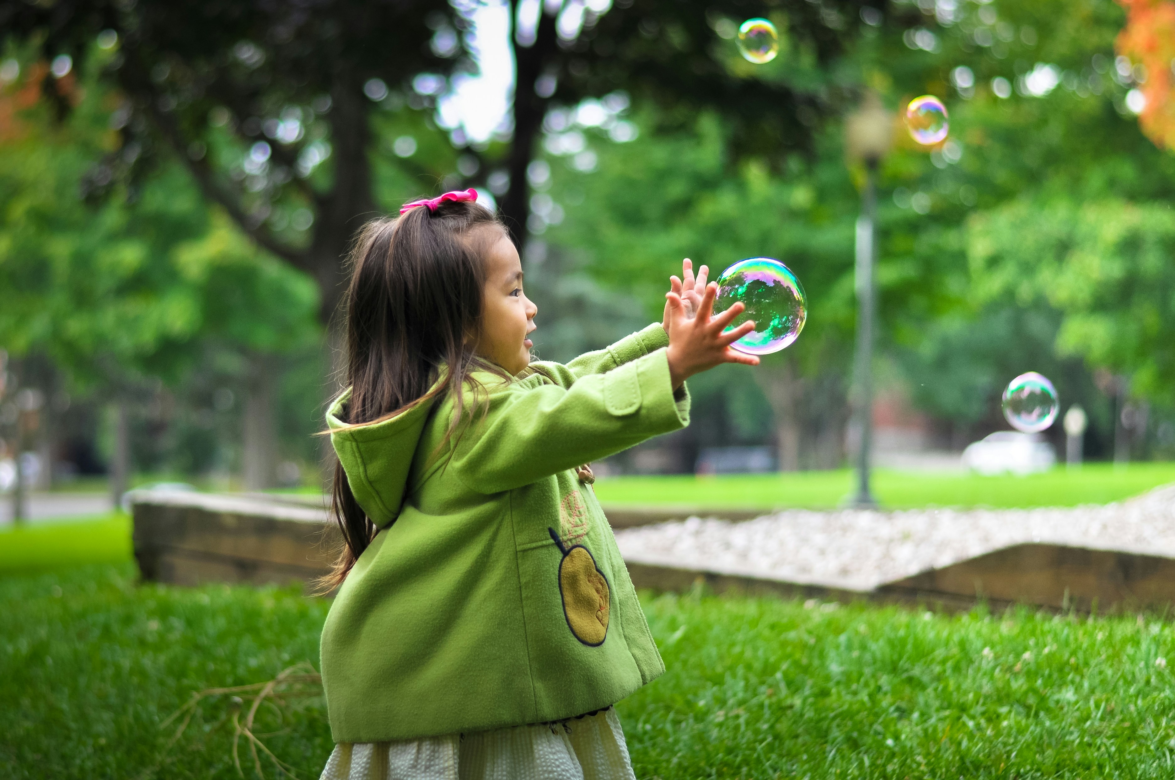 young girl playing with bubbles